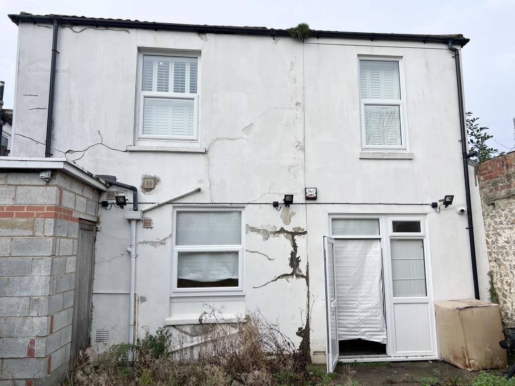 Lot: 23 - SIX-BEDROOM GUEST HOUSE - Rear elevation with painted render and windows